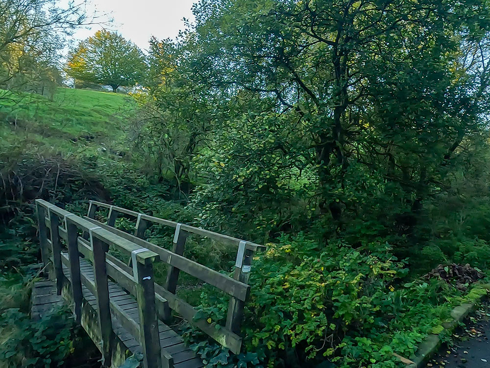 Crossing over the wooden bridge on the Pendle Witches Walk