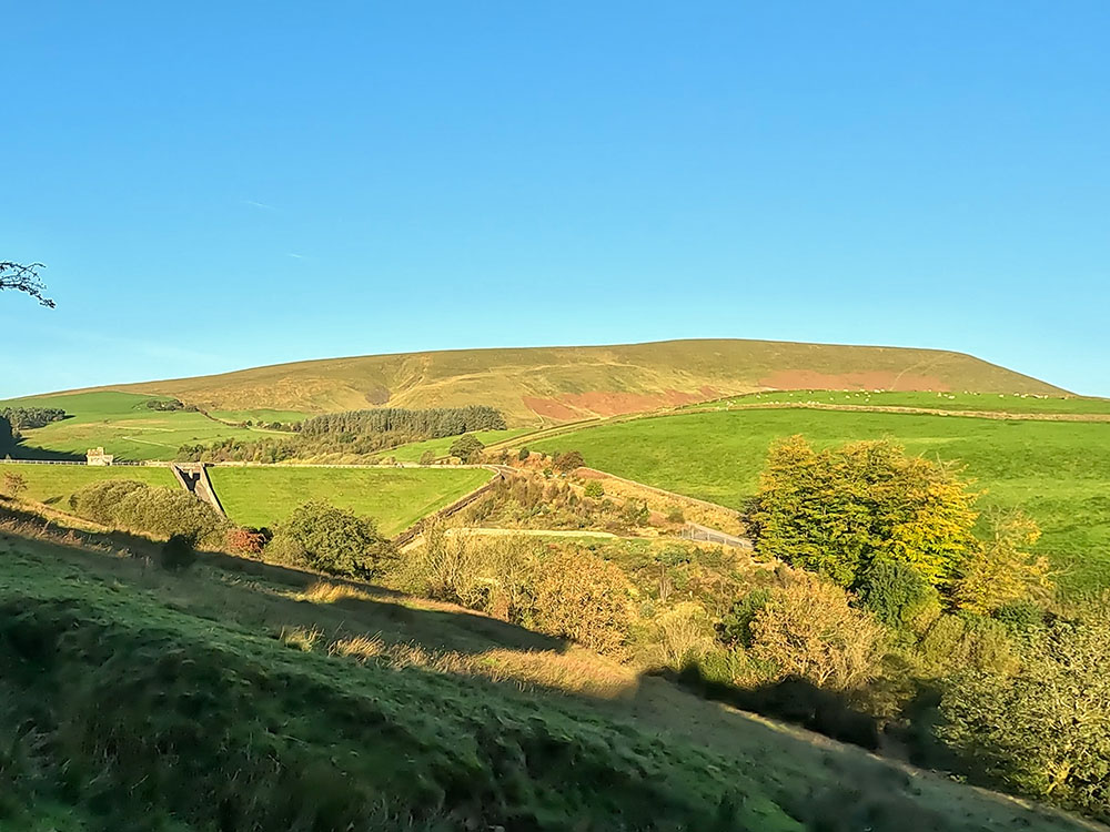 Looking across to Pendle Hill and the dam at Lower Ogden Reservoir