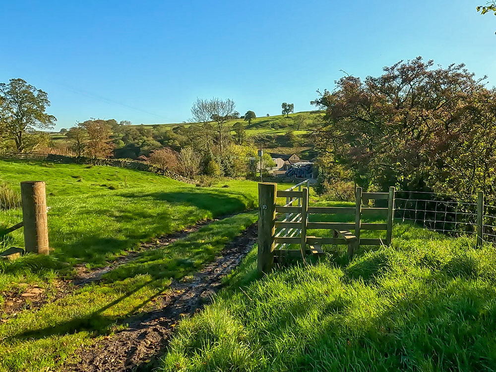 Pass over the wooden stile or through the gate if open