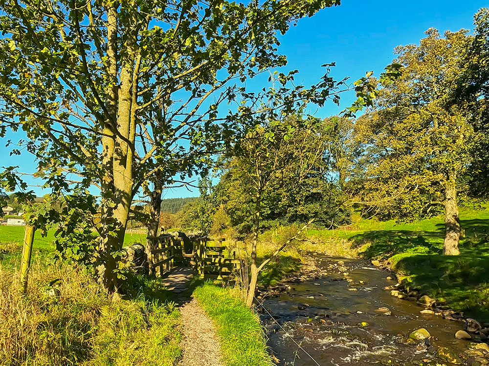 Heading along the path alongside Pendle Water