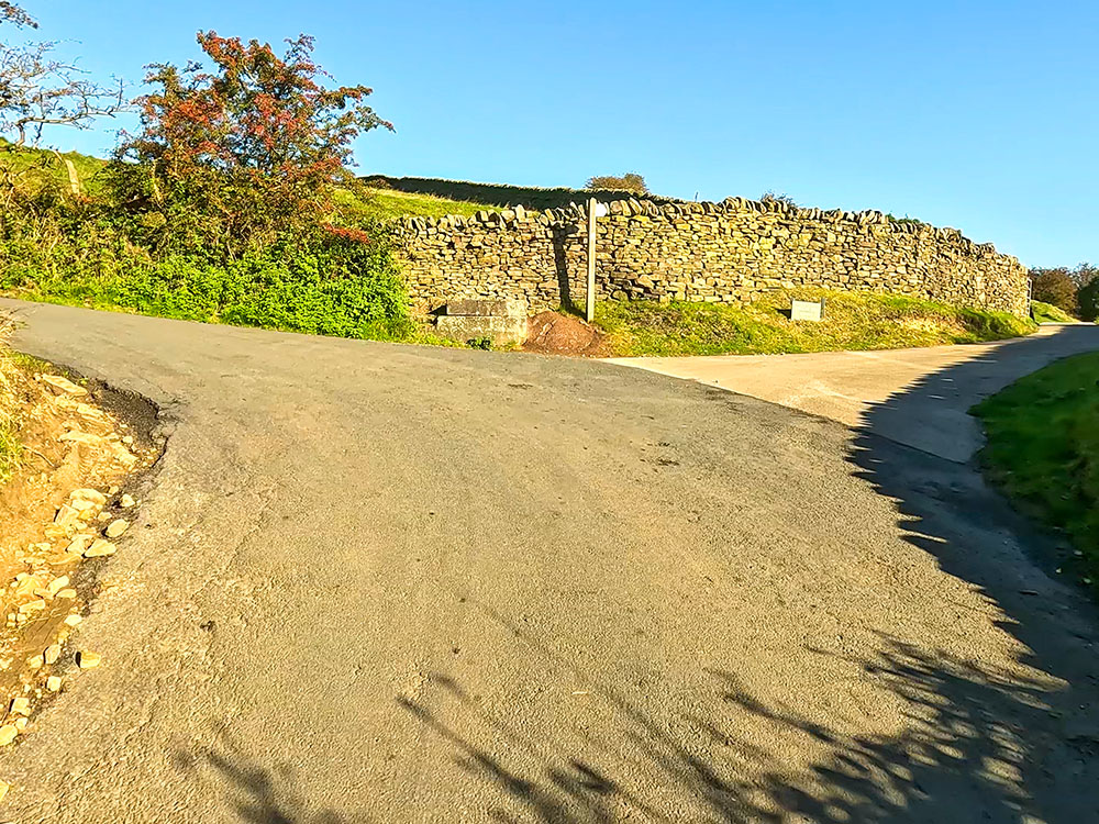 As the road bends uphill to the left, turn right off the road along the track