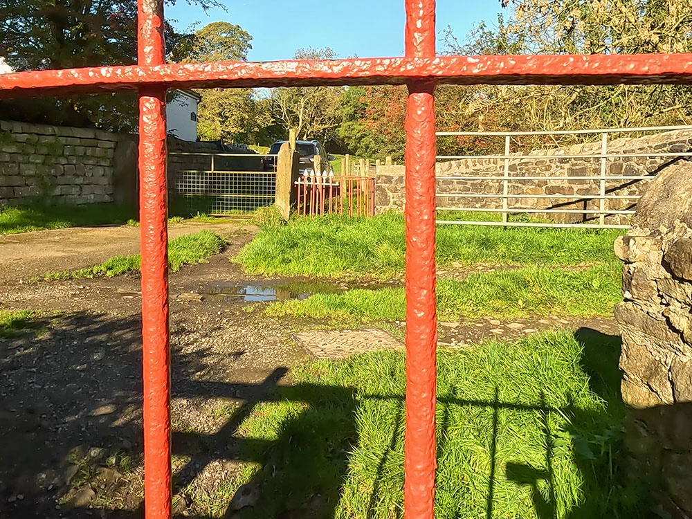 The path passes through two metal gates at Thorney Holme