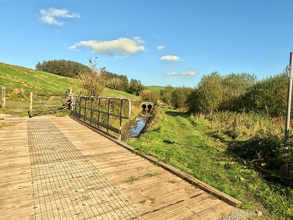 Wooden bridge from concessionary footpath back to the lane