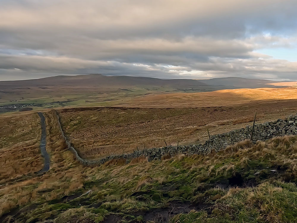 Looking back down path to Pen-y-ghent with Ingleborough on the horizon