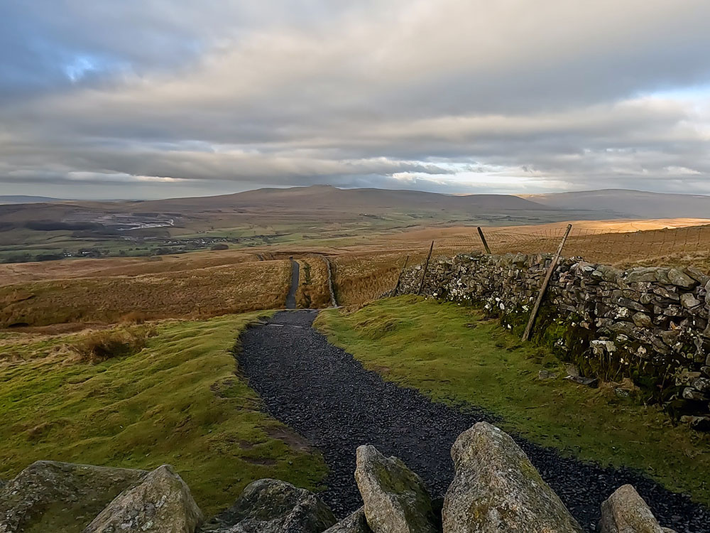 Looking back down the Pen-y-ghent path walked up from the Pennine Way with Ingleborough on the horizon