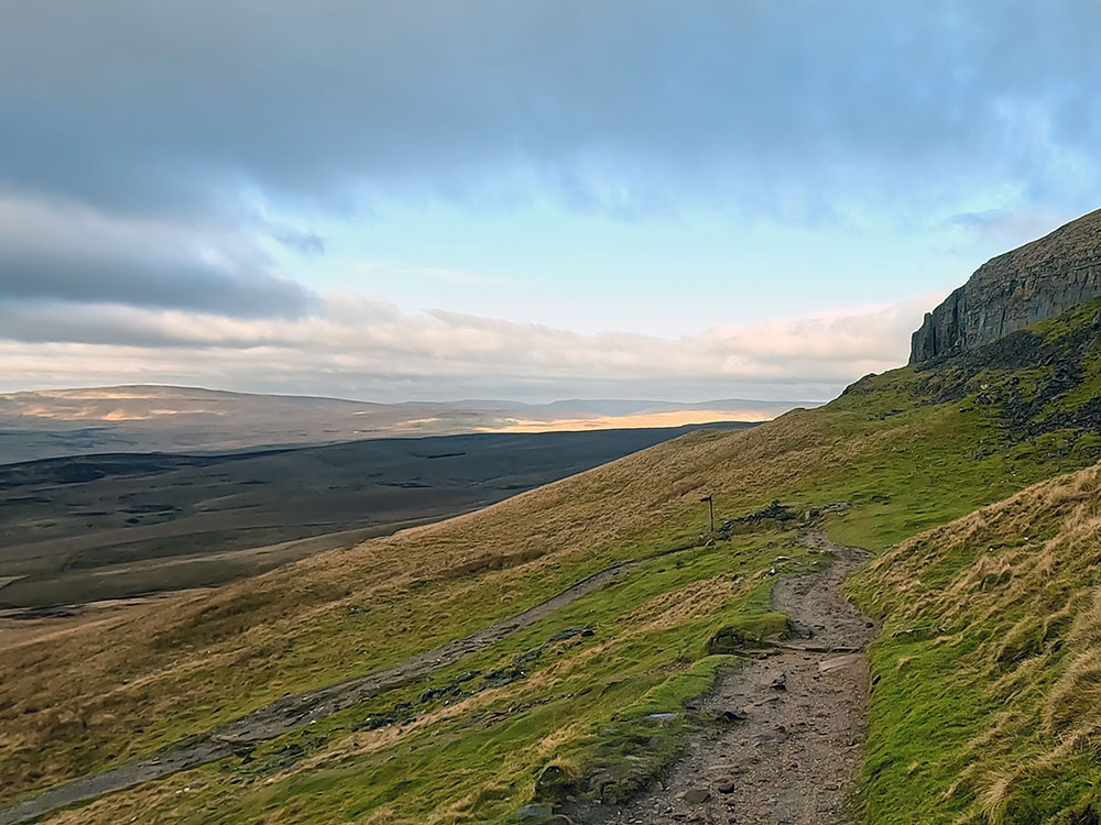 Signpost where the path swings around to the left on the Pennine Way path off Pen-y-ghent