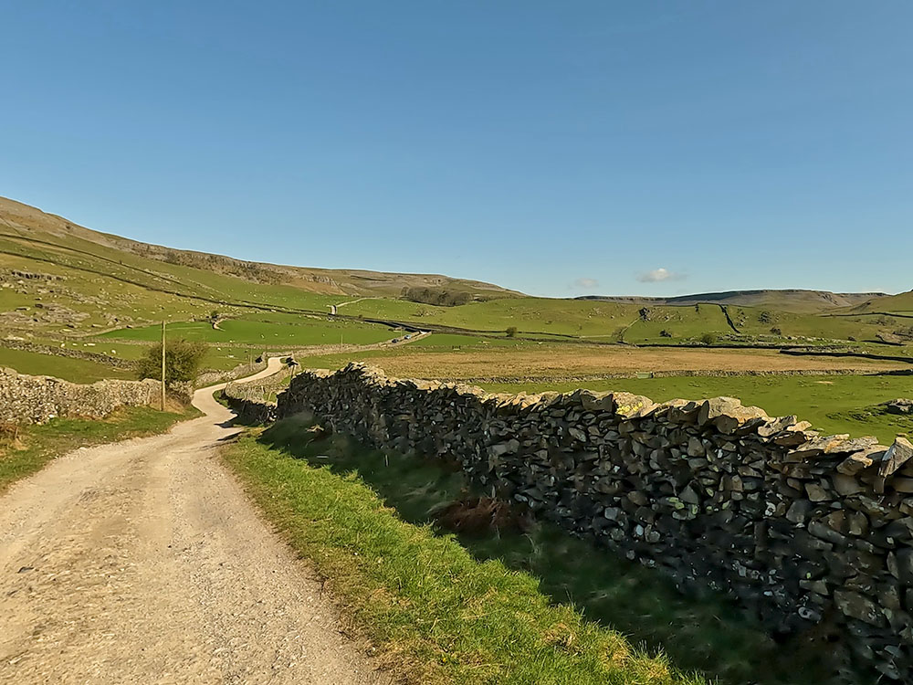 Looking back along the Dales Highway towards Moughton Scars