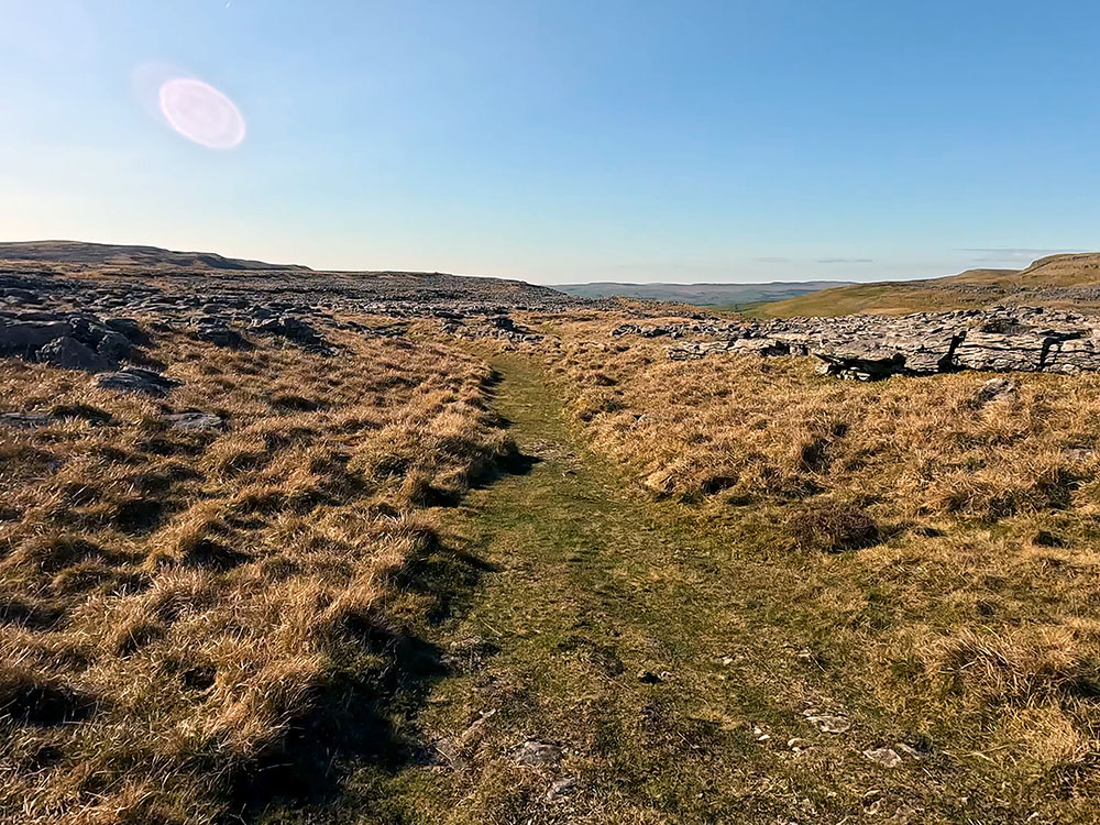 Path heading through the limestone heading towards Moughton Scars