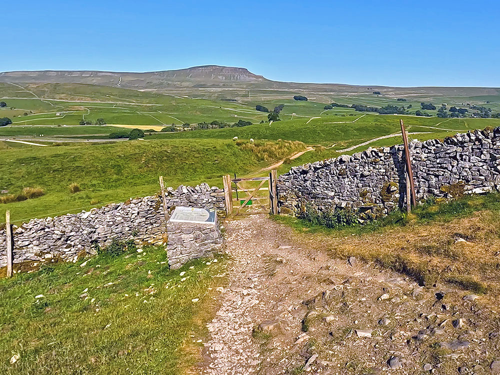 3 Peaks path passes by the information board before passing through the gate