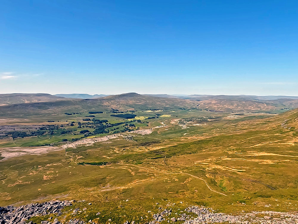 Looking across towards the Ribblehead Viaduct, Whernside and the Howgills beyond from the large boulder