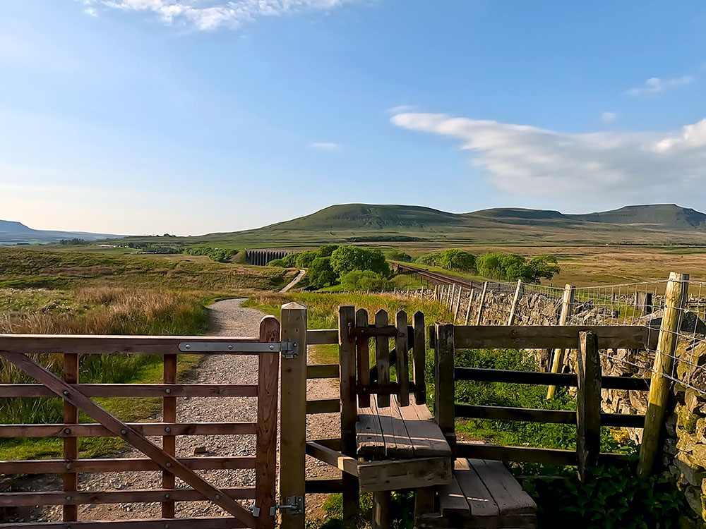 Looking back over the gate towards Pen-y-ghent on the far horizon and Ingleborough to the right