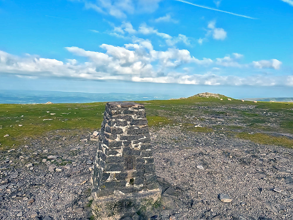 Looking over the trig point on Ingleborough out towards Morecambe Bay