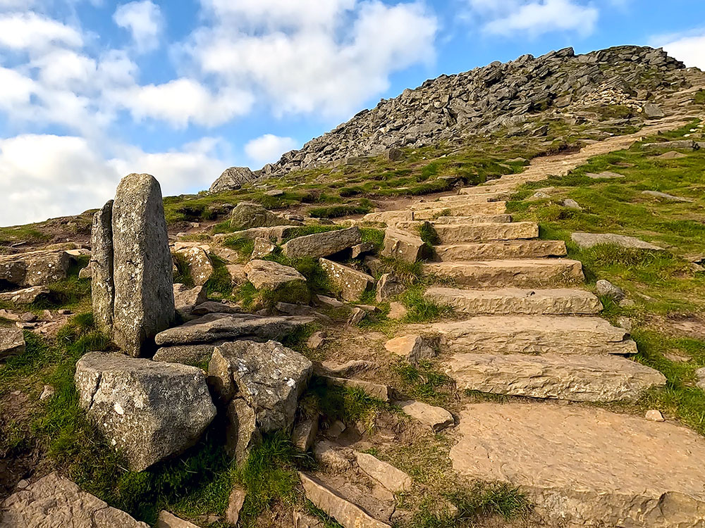 Passing by the stone waymarker that marks where the path splits on the return down from Ingleborough summit