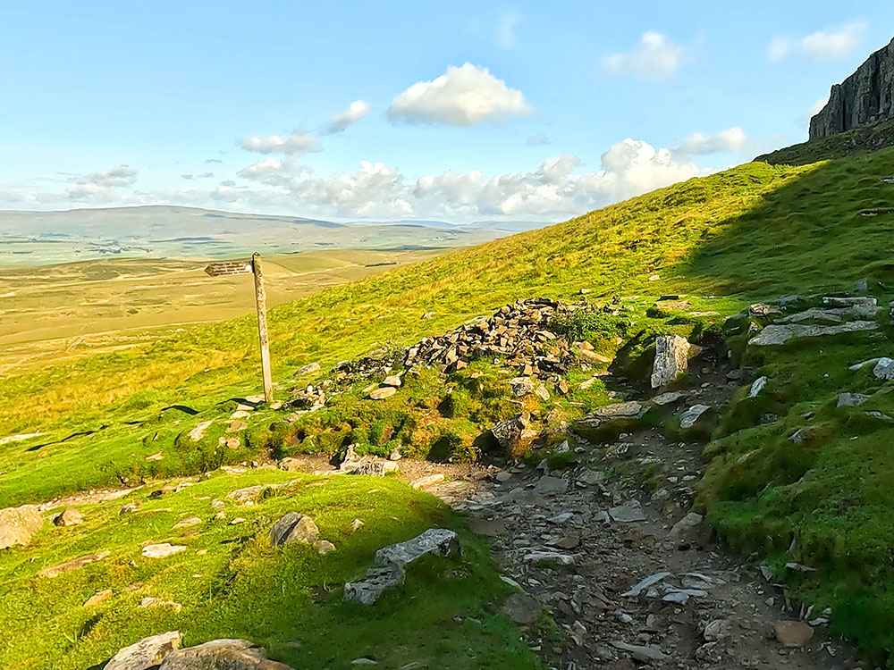 Signpost where the path heads to the left - the old 3 Peaks path went straight on here