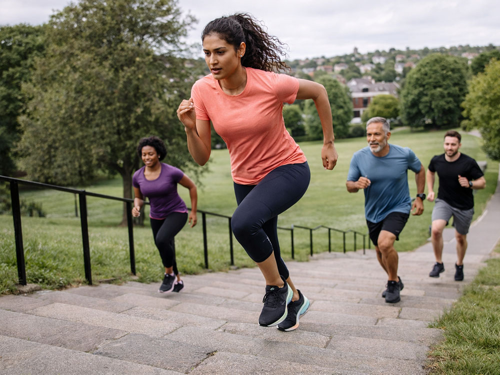 Group doing hill sprints outdoors, representing repeated high-intensity efforts where creatine may help